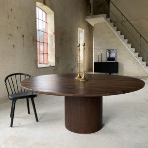Circle dining table 180 brown stained oak An inviting & tasteful round dining table in Scandinavian design, made of solid oak, which makes the table feel genuine and authentic. The round solid dining table with extension leaves is really flexible and invites to large gatherings. Solid oak is used in the manufacture of high-quality furniture because of its durability and natural beauty. Solid oak top, solid oak & plywood columns, brown stained finish. Pillar diameter 65cm. Height 74 cm. Oak is a living material with natural movements. Over time, influenced by light & humidity, shade & maturity can change