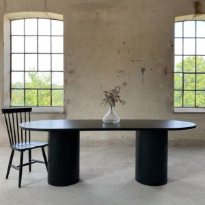 Circle dining table 220 oval with 2 pillars. Black stained oak An inviting & tasteful round dining table in Scandinavian design, made of solid oak, which makes the table feel genuine and authentic. The round solid dining table with extension leaves is really flexible and invites to large gatherings. Solid oak is used in the manufacture of high-quality furniture because of its durability and natural beauty. Solid oak top, solid oak & plywood columns, black stained finish. Pillar diameter 40cm. Height 74 cm. Oak is a living material with natural movements. Over time, influenced by light & humidity, shade & maturity can change