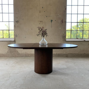 Circle dining table 150 with brown stained oak top An inviting & tasteful round dining table in Scandinavian design, made of solid oak, which makes the table feel genuine and authentic. The round solid dining table with extension leaves is really flexible and invites to large gatherings. Solid oak is used in the manufacture of high-quality furniture because of its durability and natural beauty. Solid oak top, solid oak & plywood columns, brown stained finish. Additional plate 50cm Pillar diameter 65cm. Height 74 cm. Oak is a living material with natural movements. Over time, influenced by light & humidity, shade & maturity can change