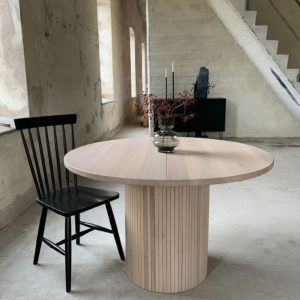 Circle dining table 115 with extension leaf. Whitewashed oak An inviting & tasteful round dining table in Scandinavian design, made of solid oak, which makes the table feel genuine and authentic. The round solid dining table with extension leaves is really flexible and invites to large gatherings. Solid oak is used in the manufacture of high-quality furniture because of its durability and natural beauty. Solid oak top, solid oak & plywood columns, whitewashed oiled finish. Additional plate 40cm Pillar diameter 50cm. Height 74 cm. Oak is a living material with natural movements. Over time, influenced by light & humidity, shade & maturity can change