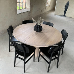 Circle dining table 150 with extension leaf. Whitewashed oak with 8 Rita 2.0 chairs in black An inviting & tasteful round dining table in Scandinavian design, made of solid oak, which makes the table feel genuine and authentic. The round solid dining table with extension leaves is really flexible and invites to large gatherings. Solid oak is used in the manufacture of high-quality furniture because of its durability and natural beauty. Solid oak top, solid oak & plywood columns, whitewashed oiled finish. Additional plate 50cm Pillar diameter 65cm. Height 74 cm. Oak is a living material with natural movements. Over time, influenced by light & humidity, shade & maturity can change